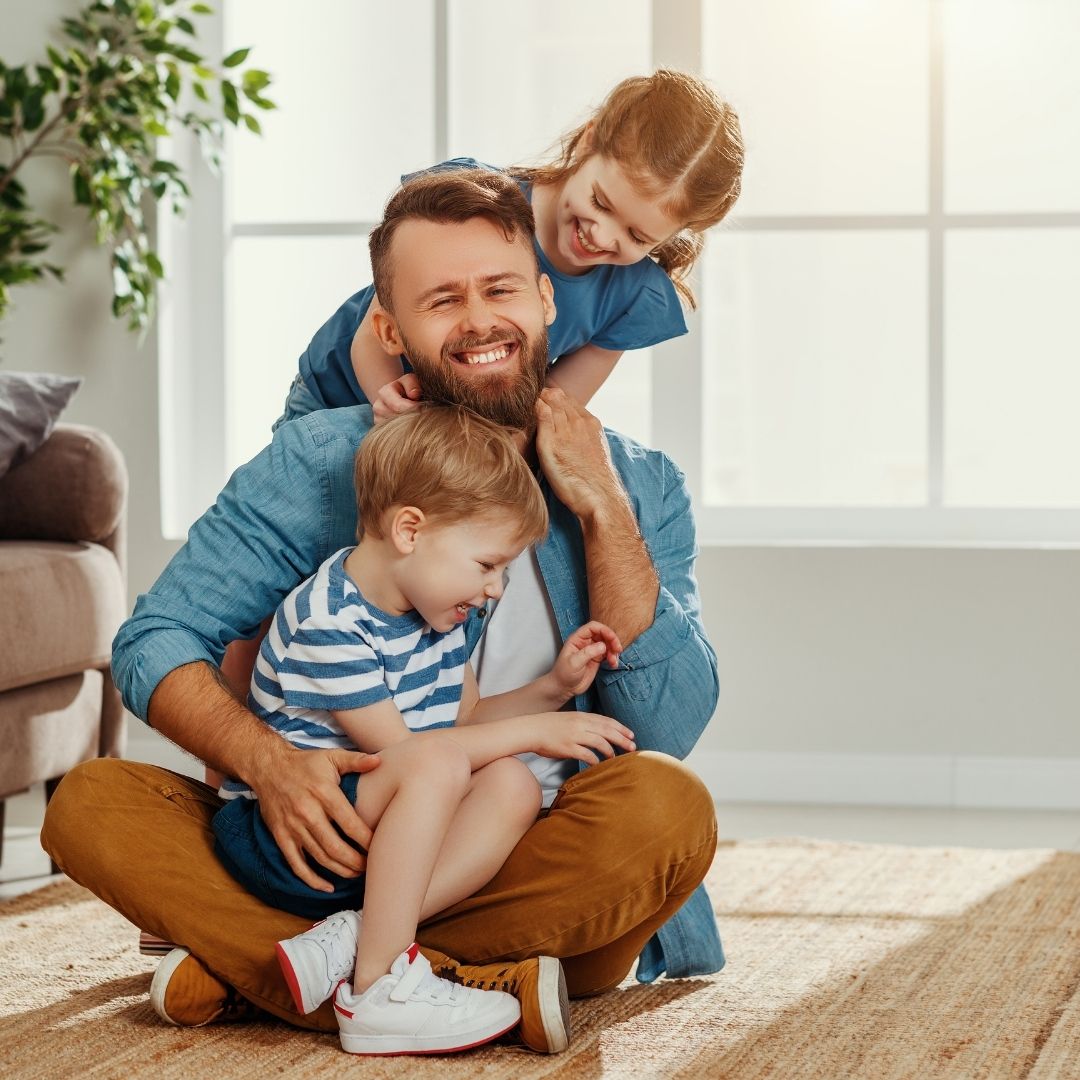 Dad playing with kids at home