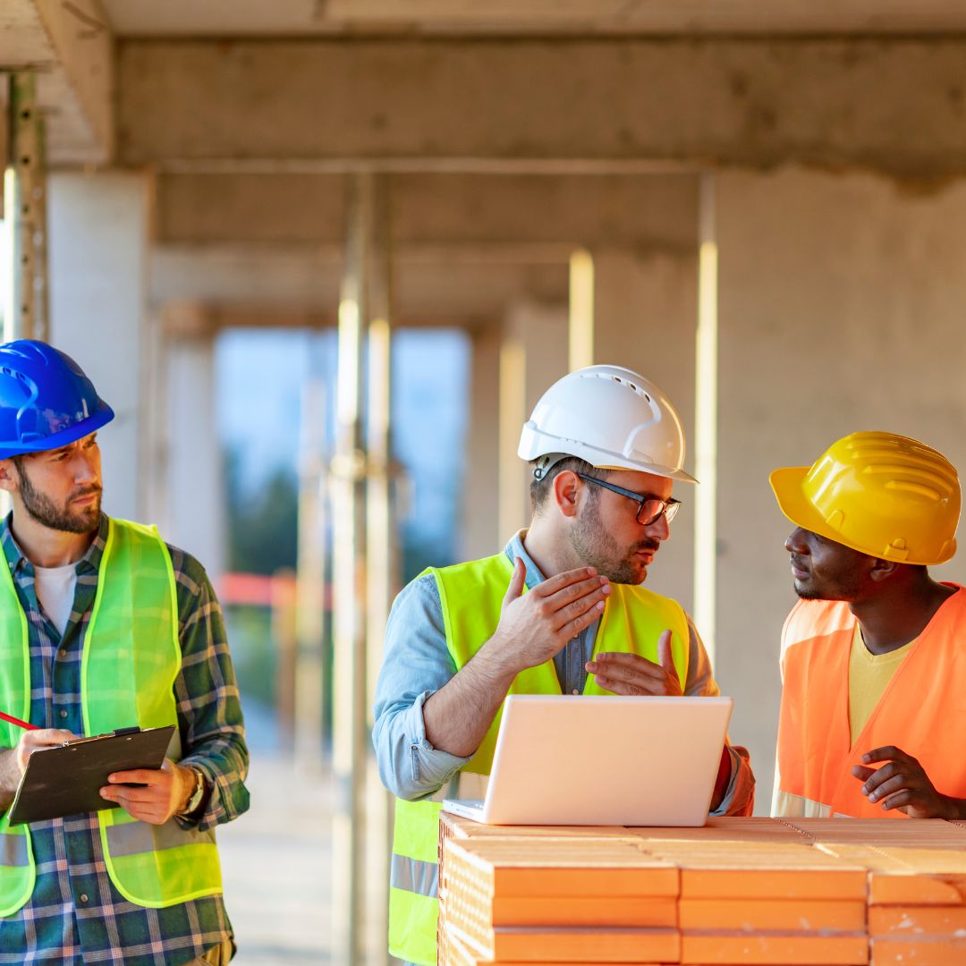 three electricians discussing on the jobsite