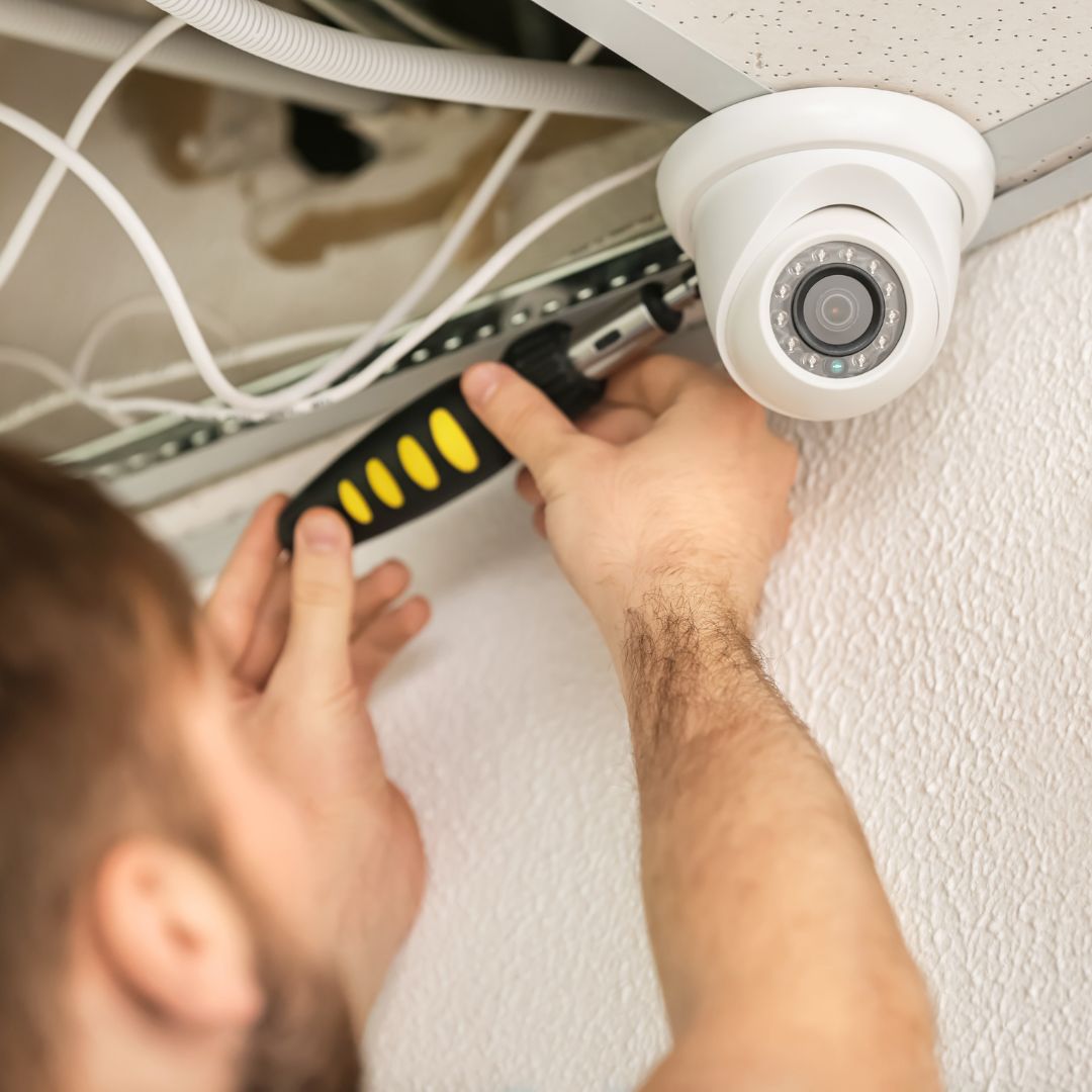 electrician installing a security camera