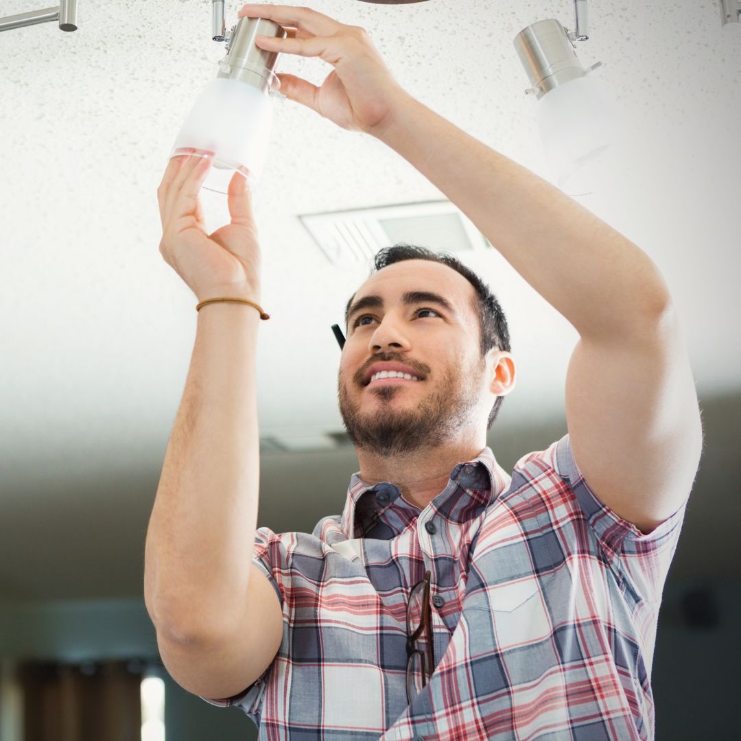 man changing light bulbs