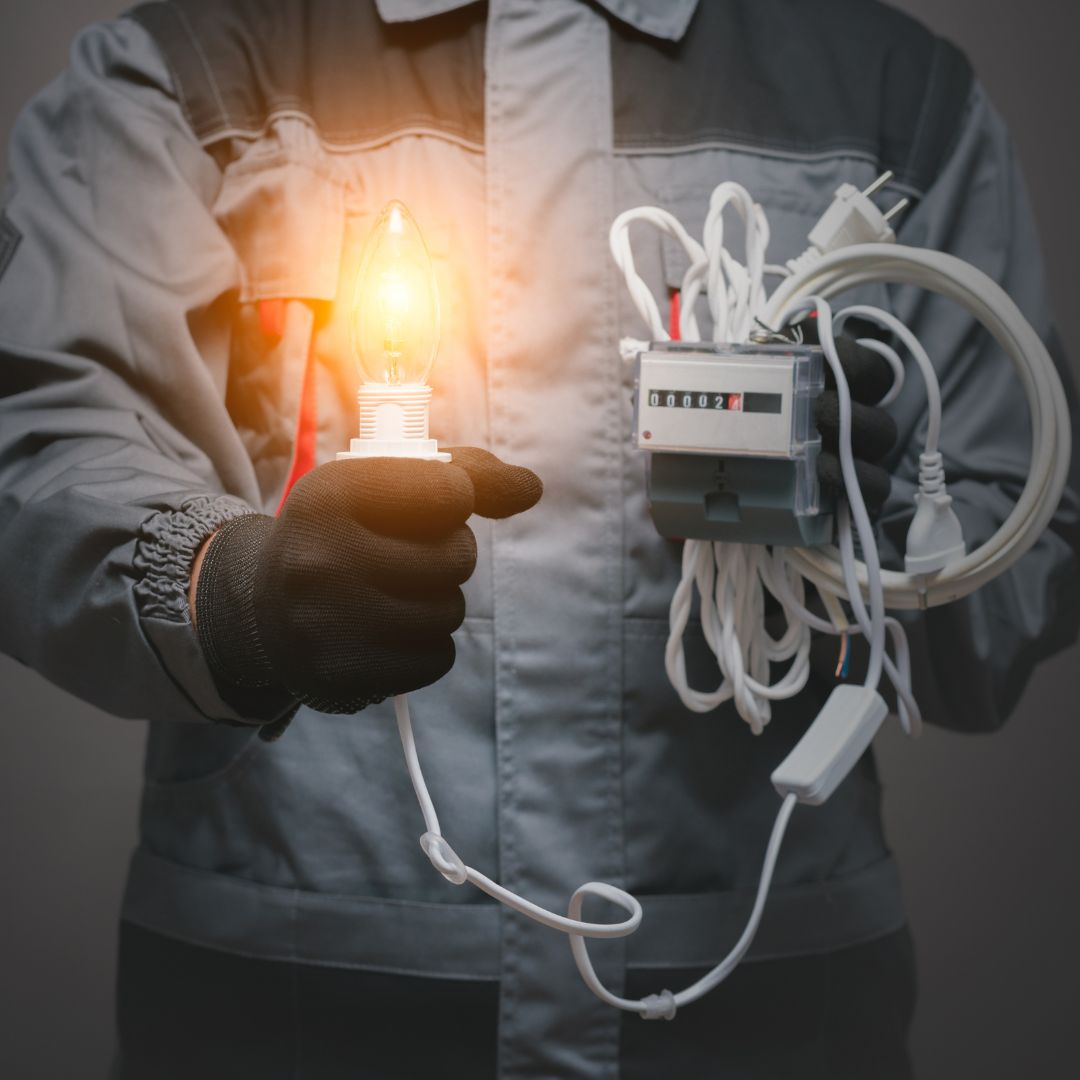 electrician holding light and cords