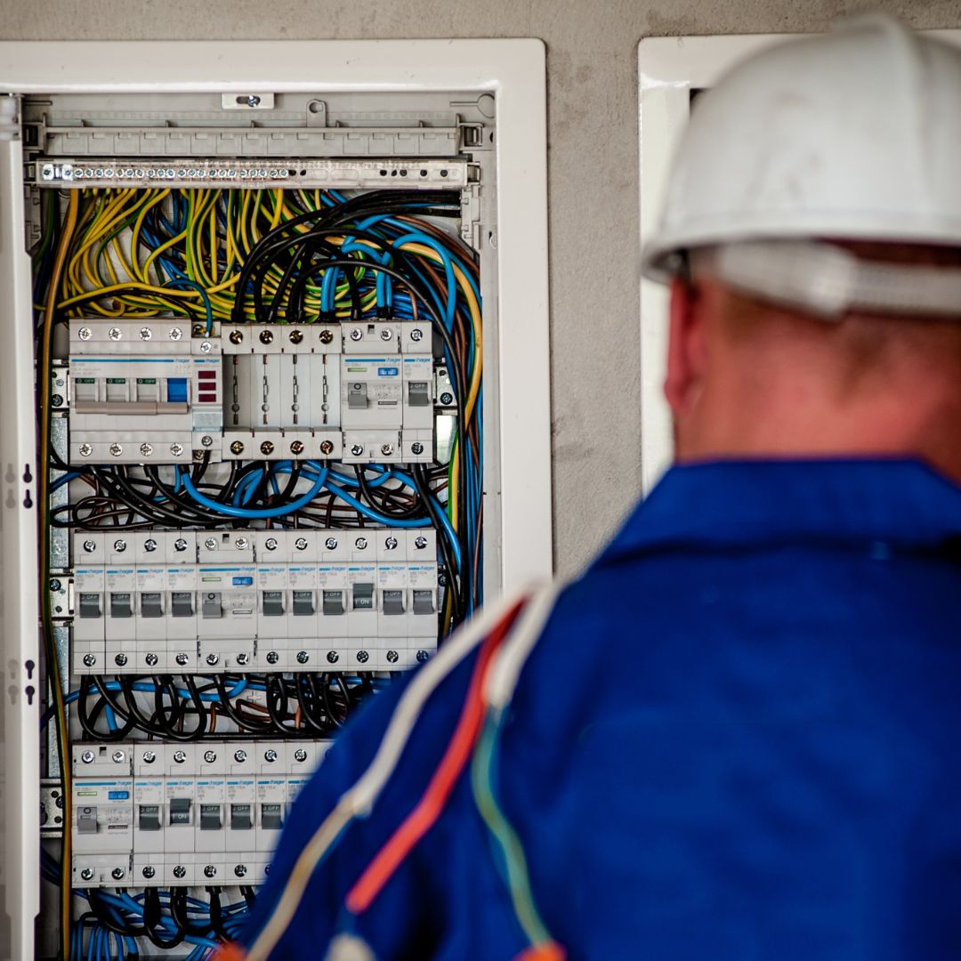 person working on electrical panel