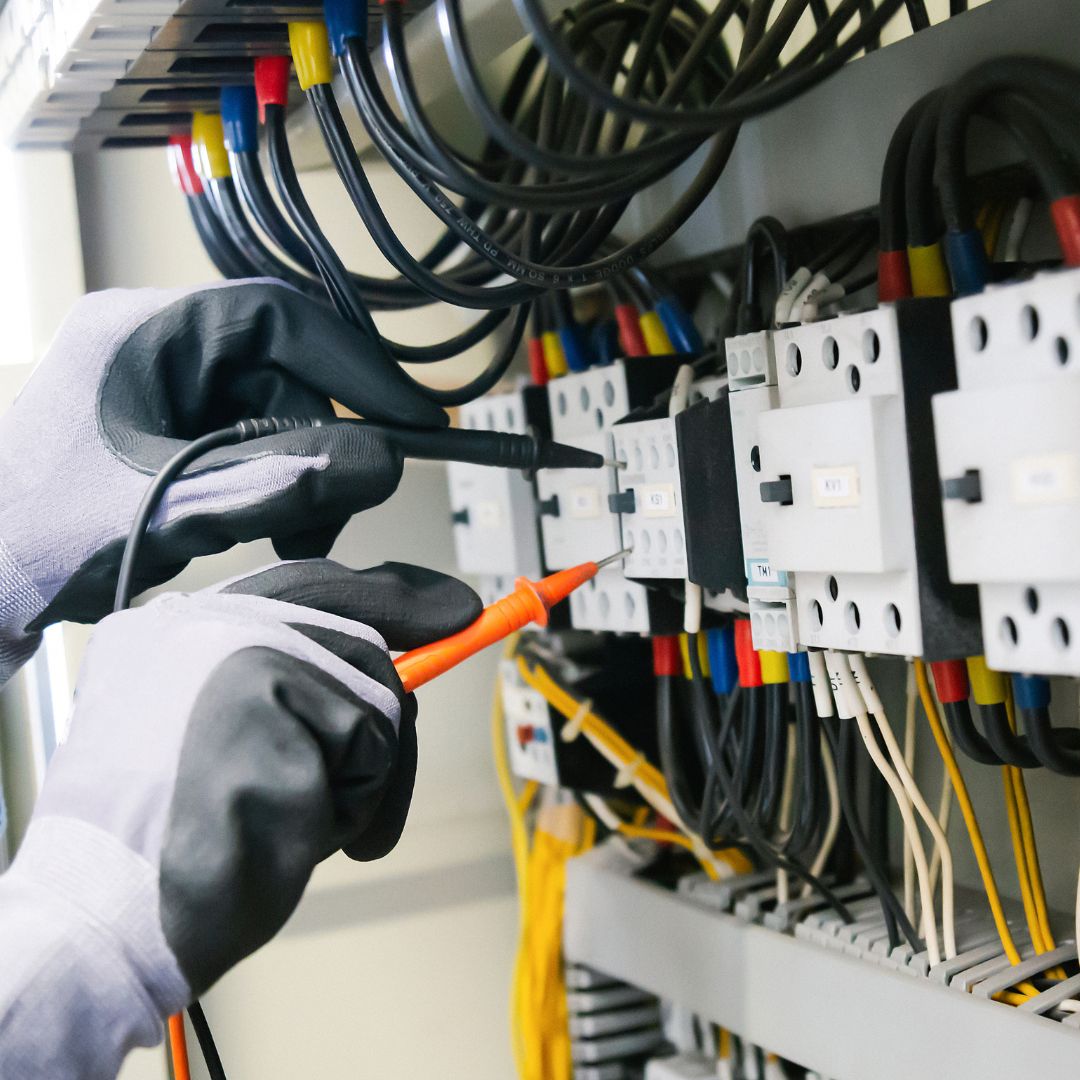 a person testing the power in a electrical box