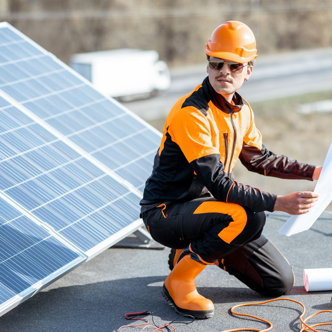 electrician standing in front of a solar panel